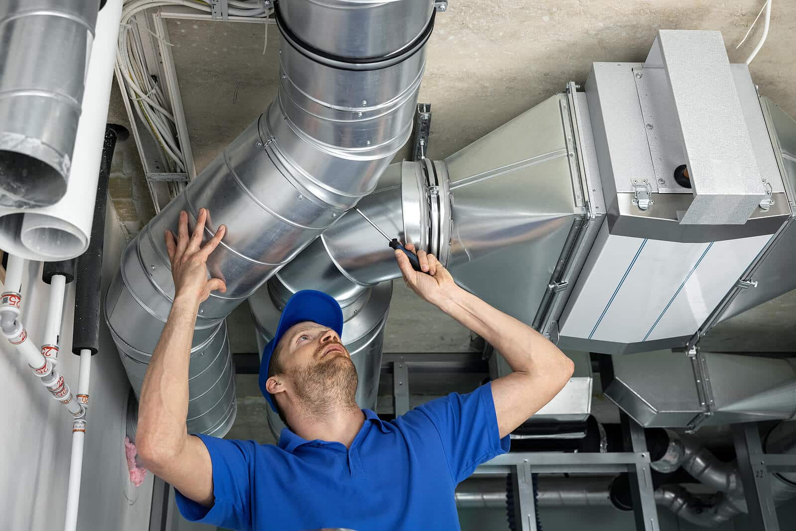 HVAC technician inspecting and repairing air ducts in Sacramento