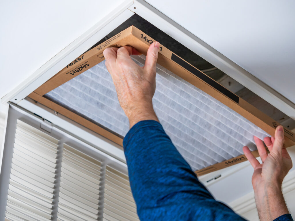 HVAC technician replacing a home air filter in Sacramento