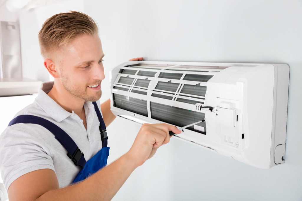 HVAC technician maintaining a ductless air conditioner in Sacramento