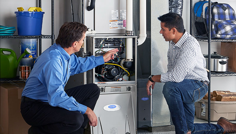Technician evaluating a furnace for repair or replacement in Sacramento