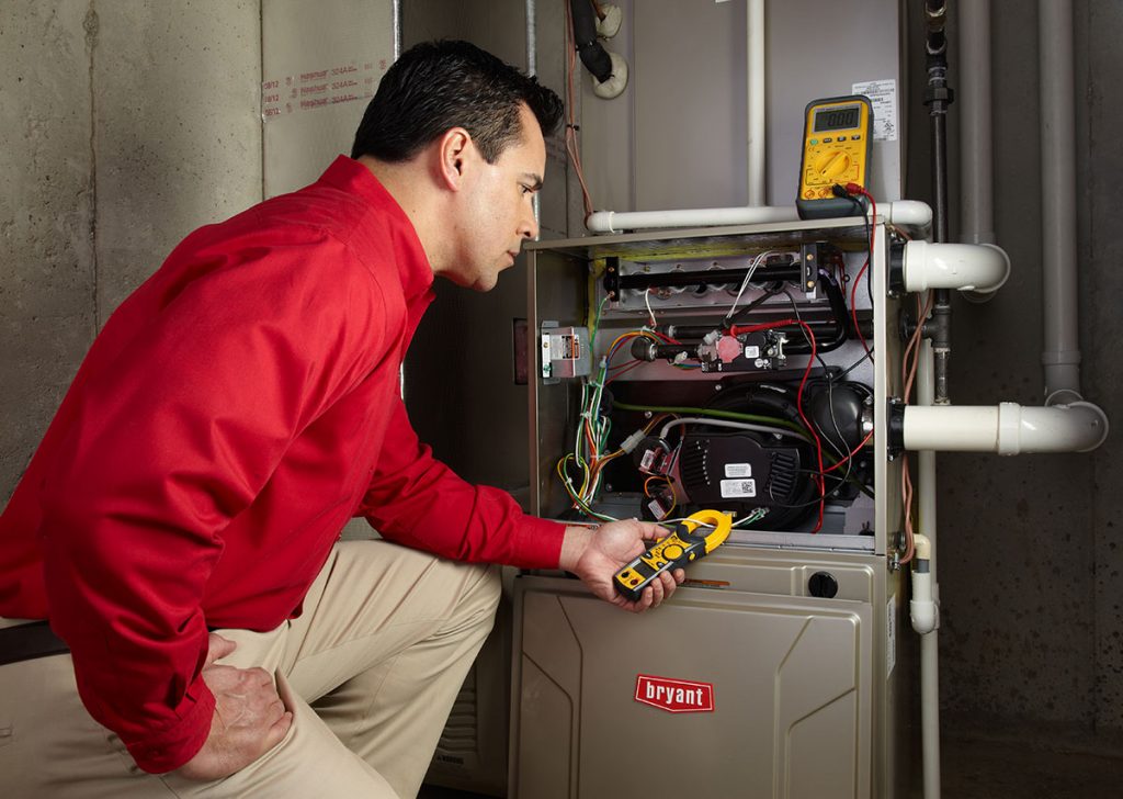 Heating technician diagnosing a furnace repair in Sacramento
