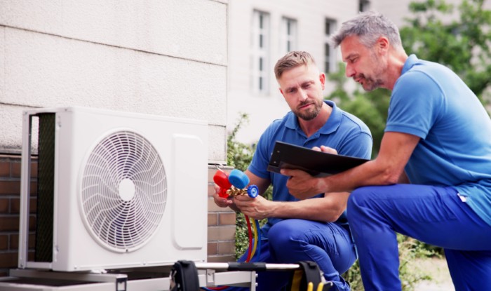 HVAC technicians installing an outdoor air conditioning unit in Sacramento