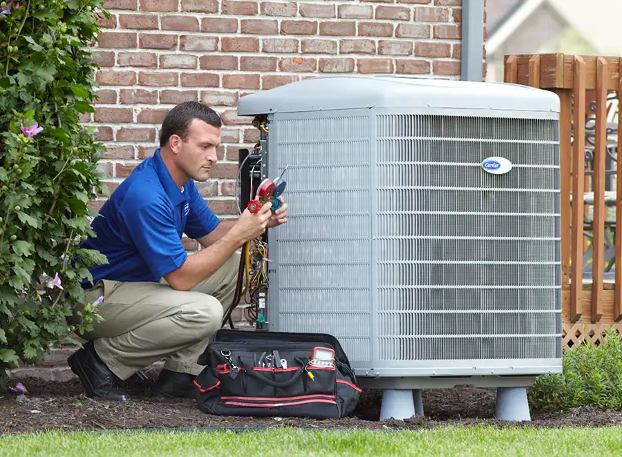 HVAC technician inspecting an outdoor AC unit in Sacramento